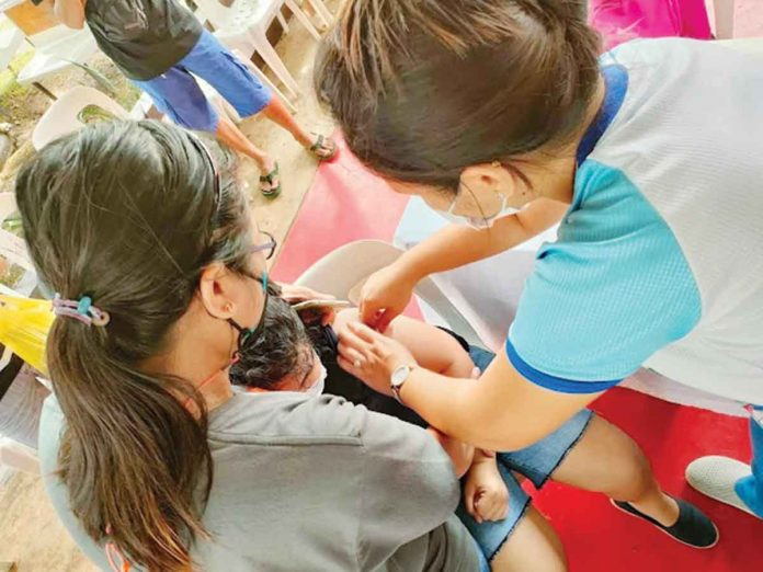 In Aklan, 59,433 people or 87.04 percent in the 12 to 17 years old age group have received at least one dose of the COVID-19 vaccine, while 57,648 or 84.43 percent got both doses. Photo shows an eligible child being vaccinated.