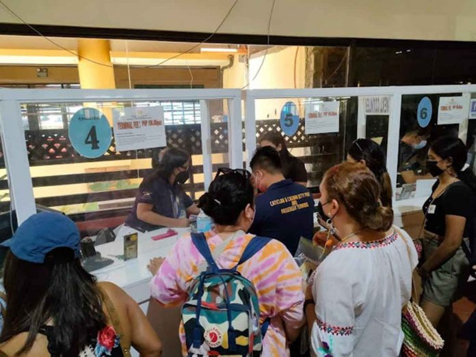 These are Boracay Island-bound tourists. At the jetty port passenger terminal in Caticlan, Malay, Aklan they have to first pay the required fees before boarding boats.