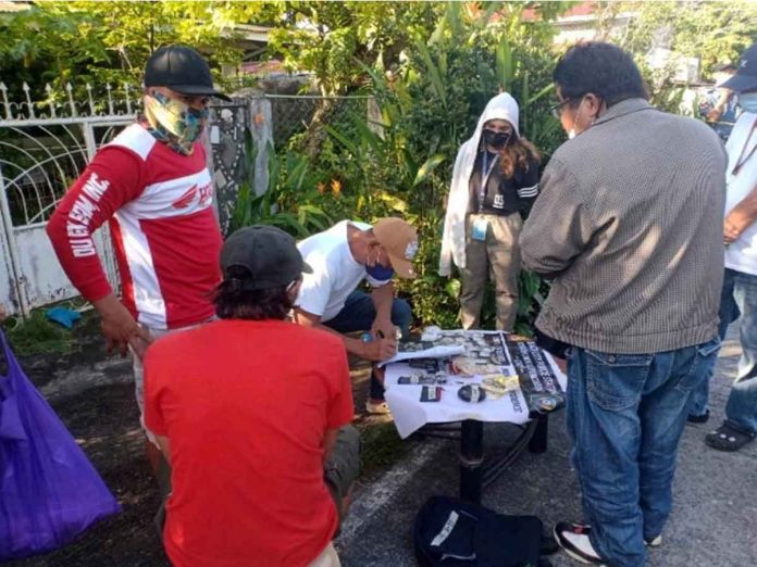 Undercover policemen check the items recovered in a buy-bust operation in Bago City, Negros Occidental. Photo by NOCPPO