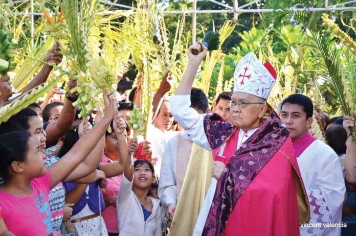 Archbishop Angel Lagdameo of Jaro is shown in this undated photo blessing palm fronds during a Palm Sunday church service. Lagdameo was appointed Archbishop of Jaro on March 11, 2000. His installation took place on May 9, 2000. PHOTO BY VINCENT VALENCIA