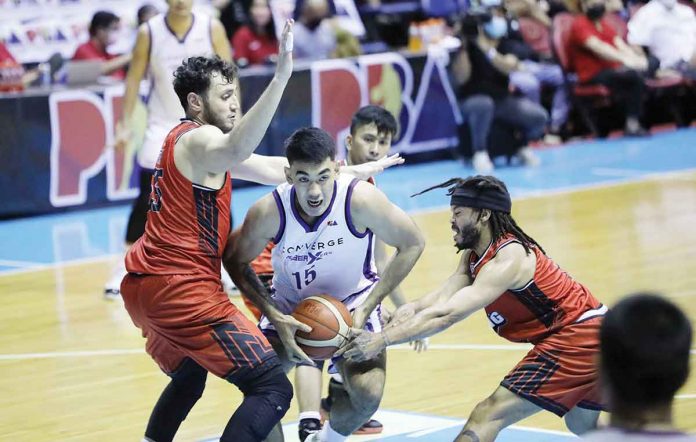 Converge FiberXers’ Justin Arana protects the ball from the defense of Blackwater Bossing’s Yousef Taha and Justin Melton. PBA MEDIA BUREAU