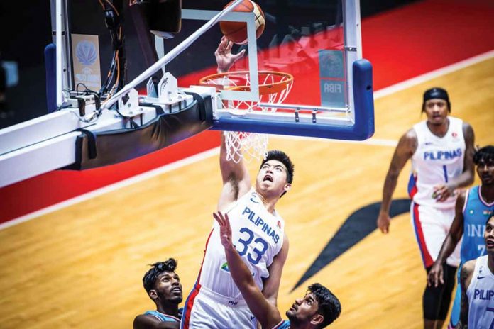 Gilas Pilipinas’ Carl Tamayo skies for a basket during their 2022 FIBA Asia Cup match against India on Friday night. FIBA PHOTO