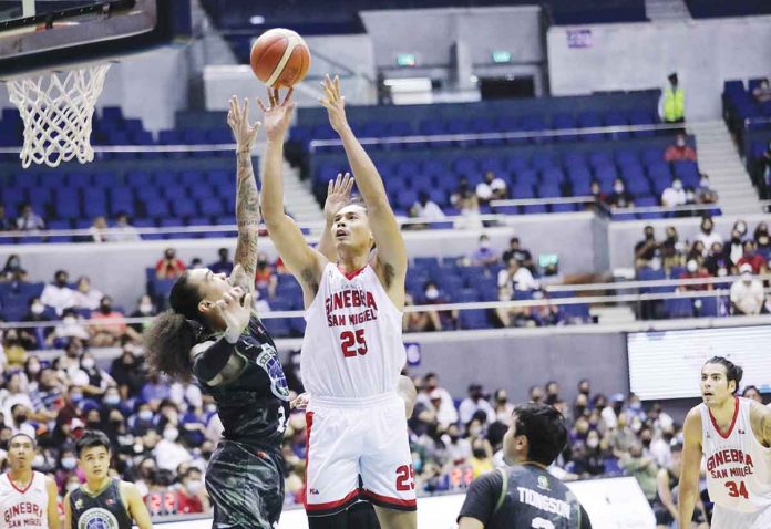 Barangay Ginebra San Miguel Kings’ Japeth Aguilar shoots over the defense of Terrafirma Dyip’s Joshua Munzon. PBA MEDIA BUREAU