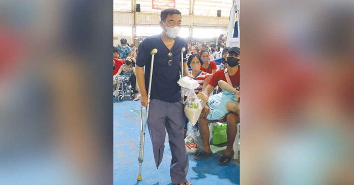 A person with disability attending an “awareness training” on disability rights in Roxas City receives free food packs. PHOTO FROM MAYOR RONNIE DADIVAS’S FB