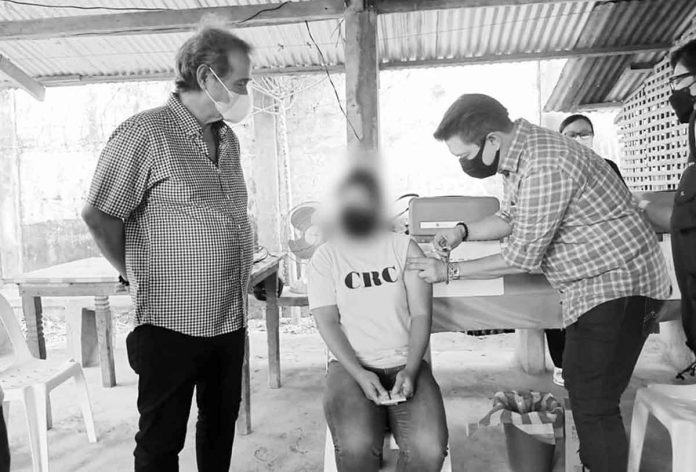 Capiz Governor Fredenil “Oto” Castro looks out as one of the persons deprived of liberty at Capiz Rehabilitation Center received her COVID-19 booster shot. CAPIZ PHO