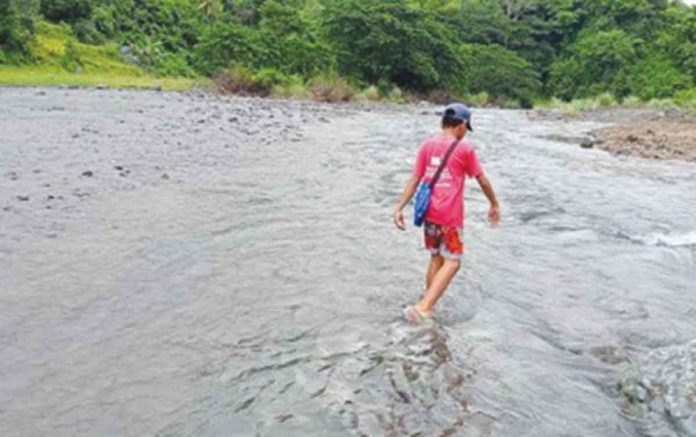 A learner from Barangay Latazon, Laua-an, Antique town crosses the Cairawan River to attend classes at the town proper in this photo taken on June 15, 2022. PNA PHOTO COURTESY OF ABEL PEDRO