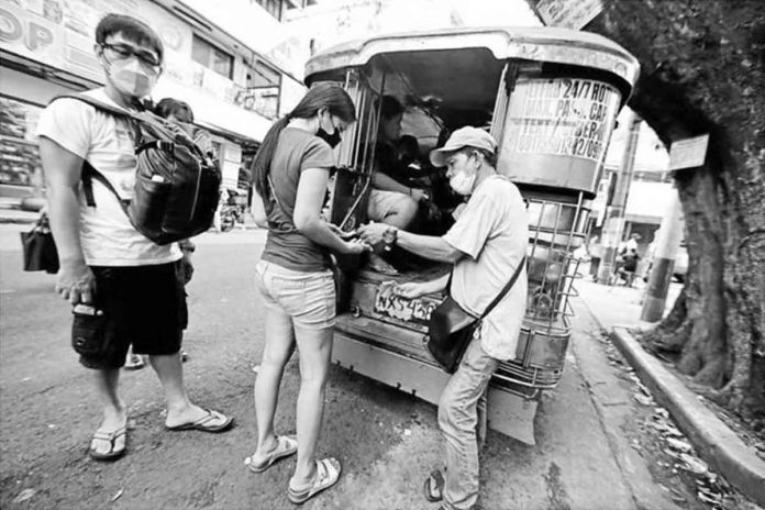 Passengers queue at a jeepney terminal in Manila on Monday. The Land Transportation Franchising and Regulatory Board next month will decide on a petition seeking to increase the current P11 minimum jeepney fare. GRIG C. MONTEGRANDE ©PHILIPPINE DAILY INQUIRER 2022