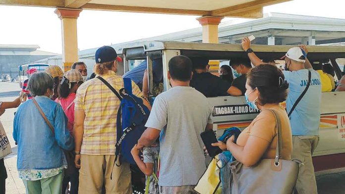 Passengers queue to board an Iloilo City-bound jeepney at the transport terminal in Barangay Tagbak, Jaro district. Next week, they would be paying more for their fare. Jeepney fares “are due for an increase already,” according to the Land Transportation Franchising and Regulatory Board. ARNEL JOHN PALCULLO/PN