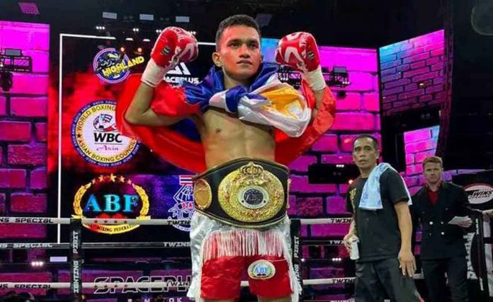 Negrense John Michael Zulueta displays his ABF light flyweight championship after defeating Thai Sittichai Nimnual in two rounds. CONTRIBUTED PHOTO