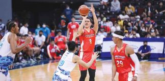 NorthPort Batang Pier’s Robert Bolick Jr. hoists a triple against the defense of Phoenix Super LPG Fuel Masters’ Tyler Tio. PBA PHOTO