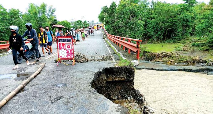 The Oyungan Bridge in Barangay Oyungan, Miag-ao, Iloilo is impassable to vehicles due to soil collapse and damaged slope protection on its approach (right side of the bridge). AJ PALCULLO/PN