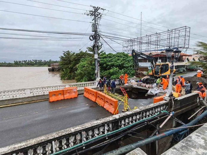 Tropical Storm “Paeng” damaged the Kalibo Bridge (Numancia side) in Aklan, causing it to close temporarily. Motorists and the riding public are advised to use the Kalibo Bridge II. Photo shows a big hole on the approach of the Kalibo Bridge (Numancia side) which, according to the Department of Public Works and Highways-Aklan, was caused by soil erosion underneath the bridge due to the strong floodwater current. ROMAR SMITH PHOTO