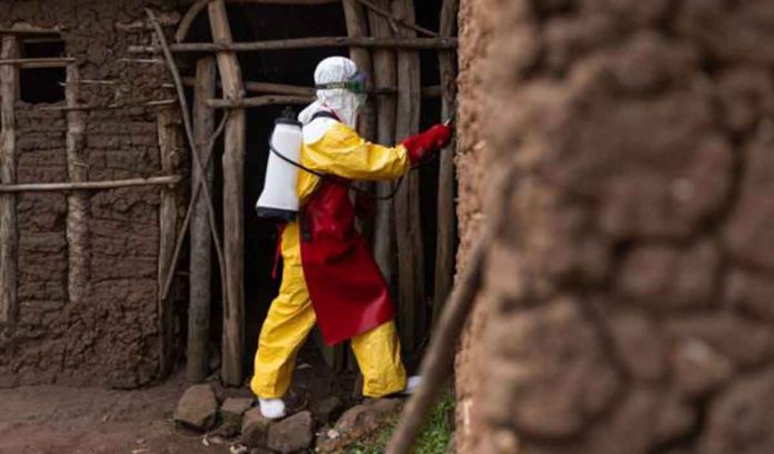 A Red Cross worker sanitizes a house in Mubende, Uganda. GETTY IMAGES