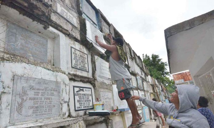 CLEANING TOMBS. This early, family members such as this man at the Pavia Catholic Cemetery in Pavia, Iloilo start cleaning the tombs of their departed loved ones in preparation for the observance of “Piesta Minatay”. AJ PALCULLO/PN