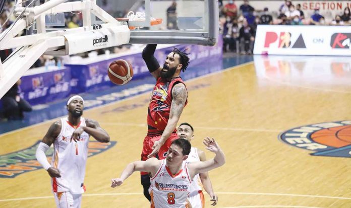 San Miguel Beermen’s Devon Scott attacks the defense of NorthPort Batang Pier’s Robert Bolick Jr. with a one-handed dunk. PBA MEDIA BUREAU