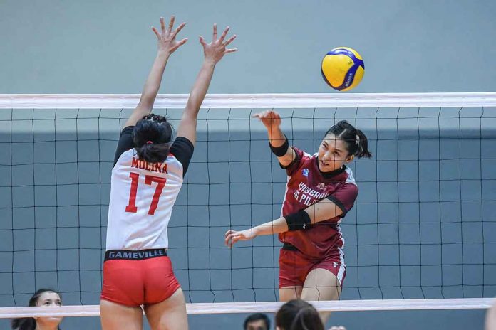 Bacolodnon Joan Marie Monares of the University of the Philippines Fighting Maroons scores against the defense of Katleya Molina of San Beda University Lady Red Spikers. V-LEAGUE PHOTO