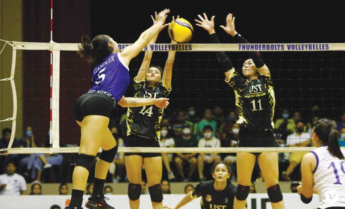 Ateneo de Manila University Blue Eagles’ Vanessa Gandler was blocked by the defense of Bacolodnon Cassie Carballo (24) and Athena Abbu (11) of University of Santo Tomas Golden Tigresses. PHOTO COURTESY OF JOSELLE MARIE B. REYES/THE VARSITARIAN