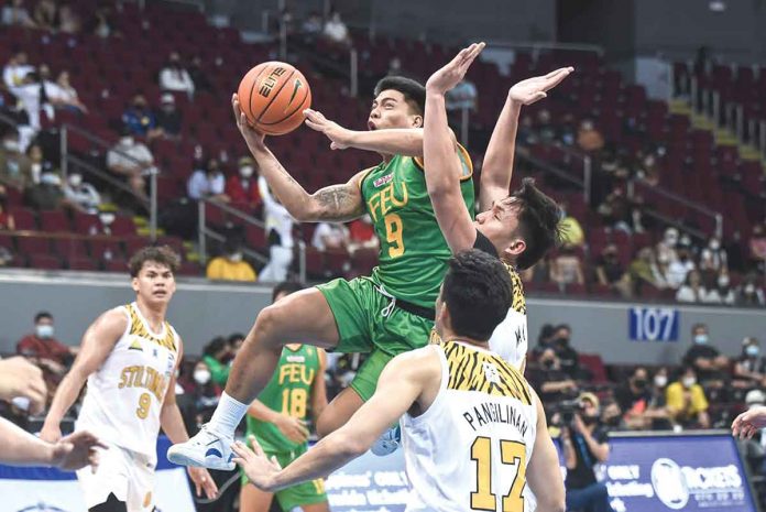 Ilonggo John Bryan Sajonia of Far Eastern University Tamaraws attacks the defense of Capiznon Christian Manaytay of University of the Santo Tomas Growling Tigers for a layup. UAAP MEDIA BUREAU PHOTO