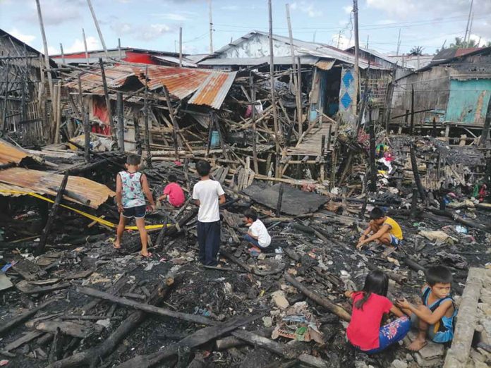 A blaze that reached second alarm status gutted 14 homes in the coastal area of Purok Kitahanon, Barangay Banago, Bacolod City on the evening of Nov. 24. No serious injuries were reported. DOMINIQUE GABRIEL G. BAÑAGA PHOTO