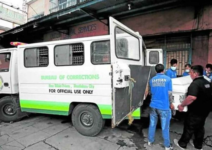 ‘FINDING THE TRUTH BEHIND THE DEATHS’. Workers of Eastern Funeral Services bring out a coffin containing the body of a deceased inmate, one of the more than 100 cadavers piled up at the funeral home since December last year. RICHARD A. REYES, PHILIPPINE DAILY INQUIRER