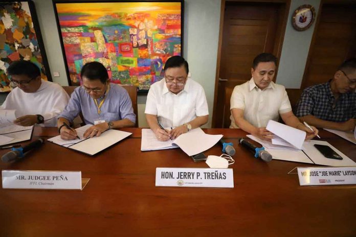 (L-R) San Jose parish priest, Rev. Fr. Renchie Vicente T. Senoro, Iloilo Festivals Foundation Inc. (IFFI) chairman Judgee Peña, Iloilo City Mayor Jerry P. Treñas, and IFFI president Jose Marie Layson Jr. sign the tripartite agreement for the 2023 staging of the Dinagyang Festival, Wednesday, Nov. 23. ILOILO CITY MAYOR’S OFFICE PHOTO