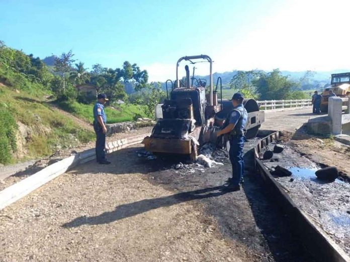 Members of the New People’s Army allegedly torched a backhoe and a road roller in Purok Magboto, Barangay Cabi-an, Candoni, Negros Occidental on Nov. 5, 2022. CANDONI PNP PHOTO