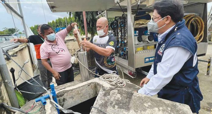 Department of Health Region 6 director Adriano Suba-an (right) says the town of Sigma in Capiz requested the use of the mobile water processing unit "for a while" as water sources in the area are still being fixed for utilization. PIA-6 PHOTO