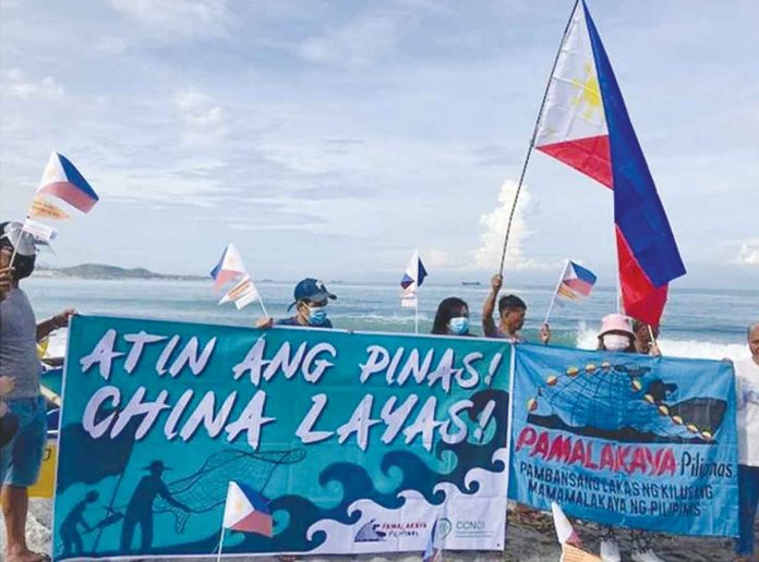 Members of Pamalakaya stage a seaside protest in Zambales on June 12, 2021, against Chinese incursions in the West Philippine Sea. PHOTO BY PAMALAKAYA