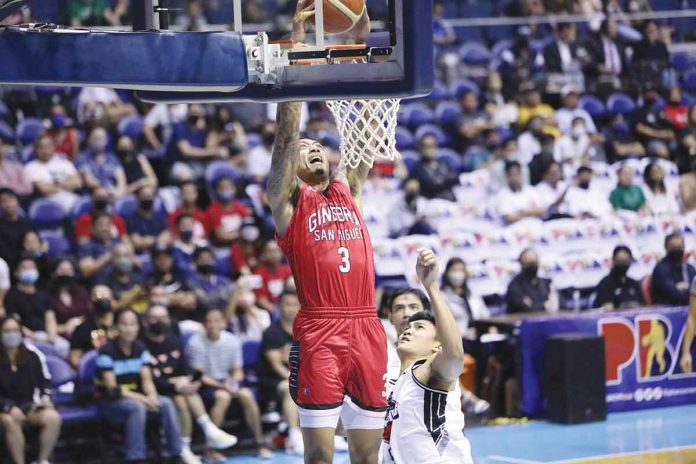 Barangay Ginebra San Miguel Kings’ Jamie Malonzo skies for a two-handed dunk as Blackwater Bossing's Renato Ular looks on. PBA PHOTO