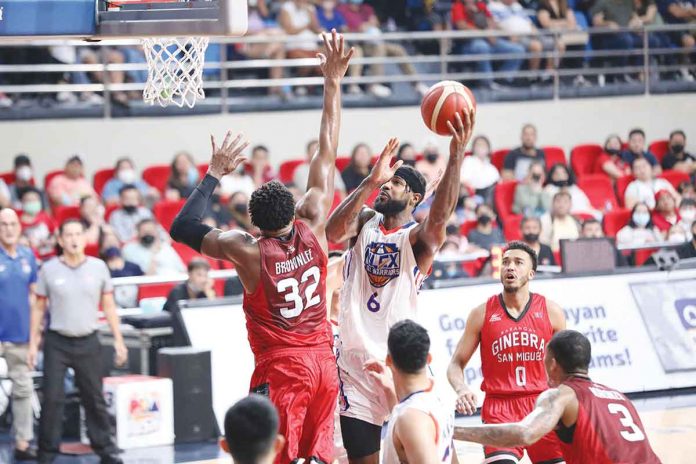 NLEX Road Warriors’ Earl Clark scores against the defense of Barangay Ginebra San Miguel Kings’ Justin Brownlee. PBA PHOTO