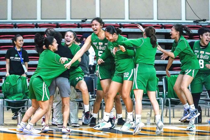 Members of De La Salle University Lady Archers celebrate following their victory over National University Lady Bulldogs. UAAP PHOTO