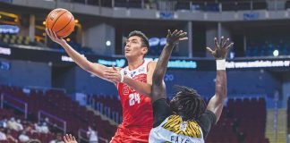 University of the East Red Warriors’ Luis Villegas attacks the defense of University of Santo Tomas Growling Tigers’ Adama Faye for an inside hit. UAAP PHOTO