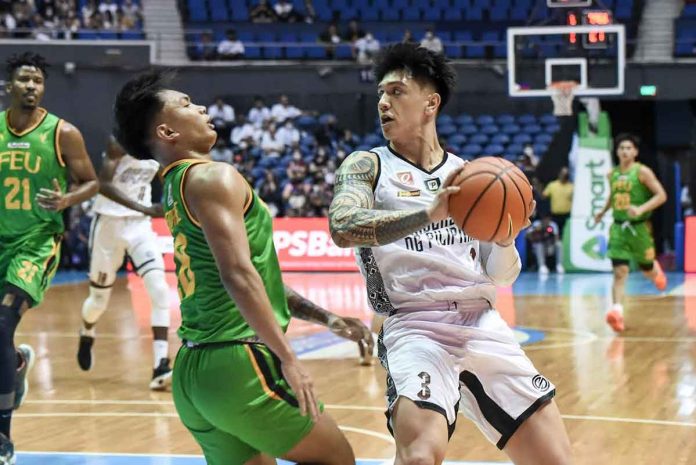 University of the Philippines Fighting Maroons’ James Spencer puts out his elbow to protect the ball from Far Eastern University Tamaraws’ Royce Alforque. UAAP MEDIA BUREAU