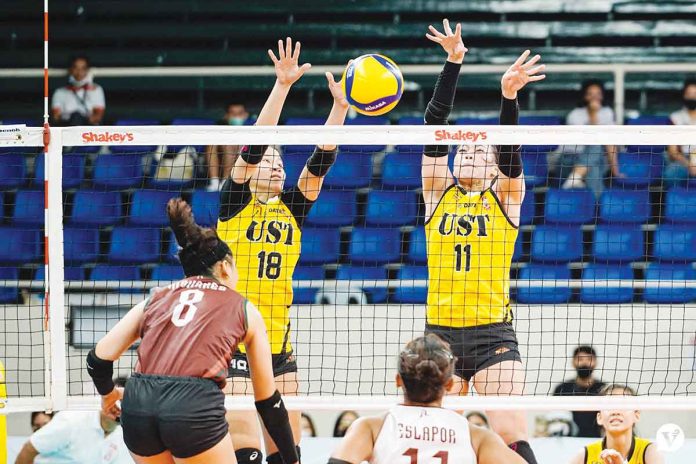 University of Santo Tomas Golden Tigresses’ Regina Jurado and Athena Abbu foil the attack of Bacolodnon Joan Marie Monares of the University of the Philippines Fighting Maroons. VARSITARIAN SPORTS PHOTO