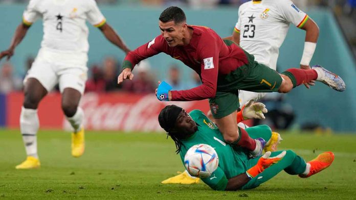 Portugal’s Cristiano Ronaldo falls over Ghana goalkeeper Lawrence Ati-Zigi. AP