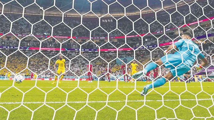 Enner Valencia scores past Qatar’s goalkeeper Saad Al Sheeb for Ecuador’s opening goal. AP