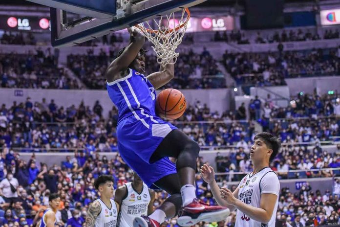 Ateneo de Manila University Blue Eagles’ Angelo Kouame scores on a two-handed dunk as University of the Philippines Fighting Maroons’ Carl Tamayo looks on. UAAP PHOTO