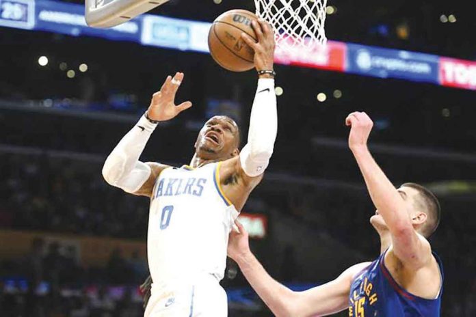 Los Angeles Lakers guard Russell Westbrook goes to the basket against Denver Nuggets center Nikola Jokić during their 2022-2023 NBA Season game in Los Angeles. AP PHOTO/MICHAEL OWEN BAKER