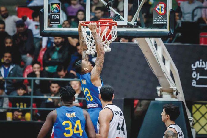 Gilas Pilipinas’ Jamie Malonzo pulls up a two-handed dunk after evading the defense of Jordan. FIBA PHOTO