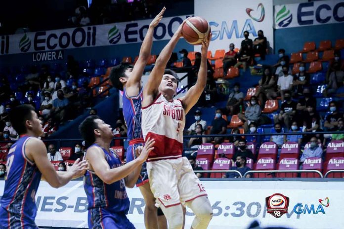 San Beda University Red Lions’ John Bahio goes for an inside hit against an Arellano University Chiefs defender. PHOTO BY NCAA/GMA SPORTS