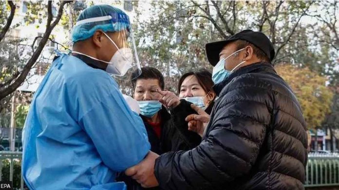 Desperate Chinese citizens confront a healthcare worker. EPA