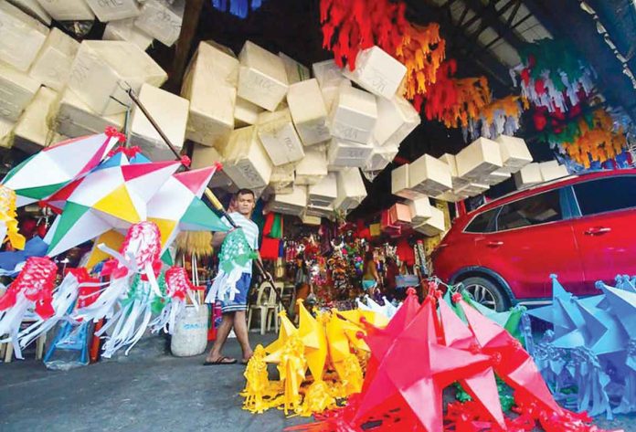 A worker arranges lanterns on sale in a market in Quezon City. MARK DEMAYO/ABS-CBN NEWS PHOTO