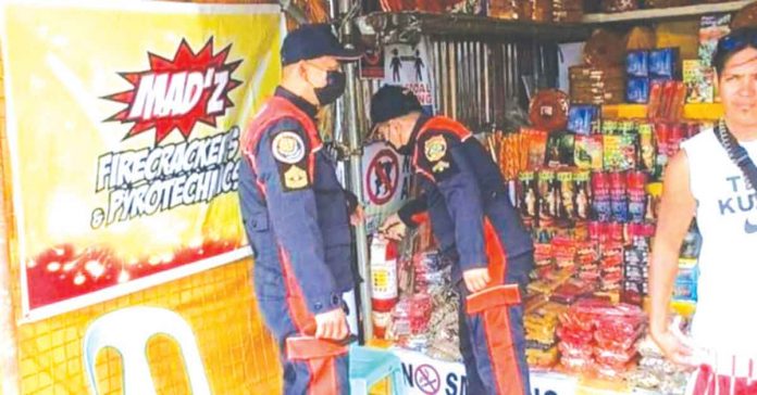 Personnel of the Bureau of Fire Protection in Bacolod City inspect a firecrackers stall at the Reclamation Area on Dec. 27, 2022. BFP-BACOLOD CITY RODRIGUEZ FIRE SUB-STATION