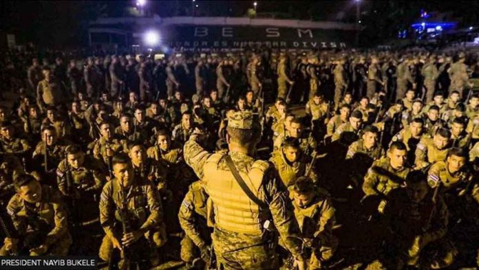 This photo released by the government of El Salvador shows heavily armed troops clad in body armor and carrying assault rifles outside the city of Soyapango. BBC