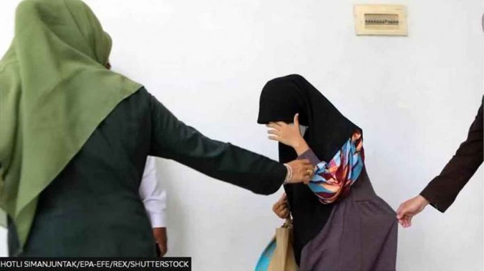 A woman in Aceh, Indonesia, before being caned in November for having sex outside of marriage. Aceh province already has strict laws against sex outside marriage.