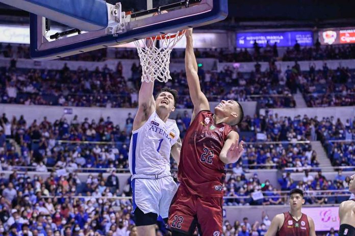 Ateneo de Manila University Blue Eagles’ Bryson Ballungay scores on a dunk against the defense of the University of the Philippines Fighting Maroons’ Zavier Lucero. UAAP PHOTO