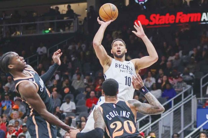 Brooklyn Nets’ Ben Simmons nearly lost control of the ball after being bothered by the defense of Atlanta Hawks' John Collins. USA TODAY PHOTO