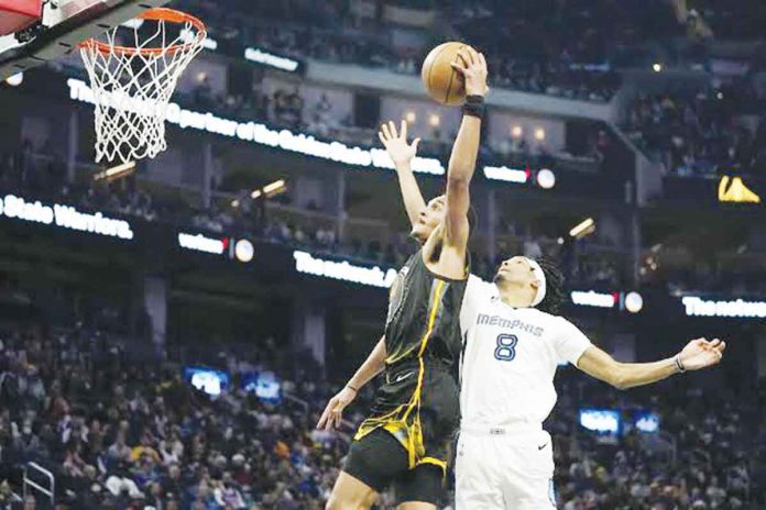 Golden State Warriors Jordan Poole (No. 3) shoots while being defended by Memphis Grizzlies forward Ziaire Williams (No. 8) during the first half of an NBA basketball game in San Francisco, Sunday, Dec. 25, 2022. AP