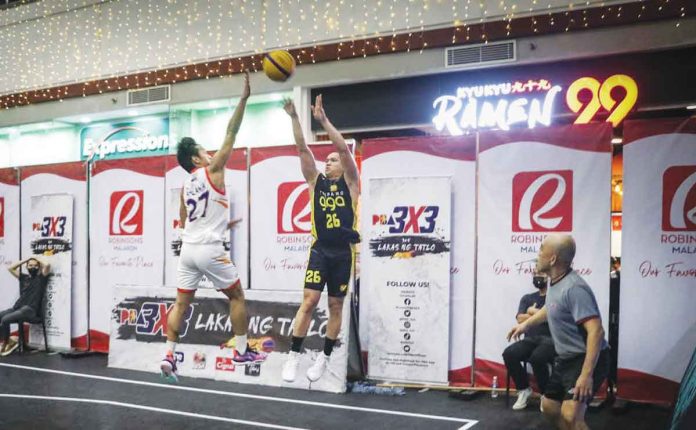 TNT Tropang Giga’s Almond Vosotros attempts a three-pointer against the defense of CAVITEX Braves’ Pedrito Galanza. PBA PHOTO