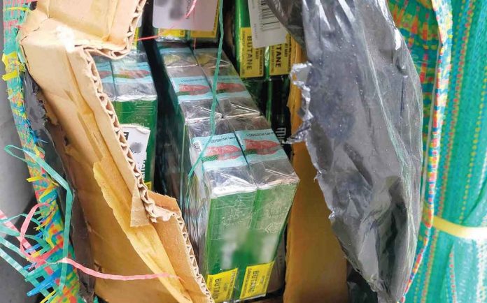 A total of 102 boxes of alleged counterfeit cigarettes were seized from a Chinese national. RMN ROXAS